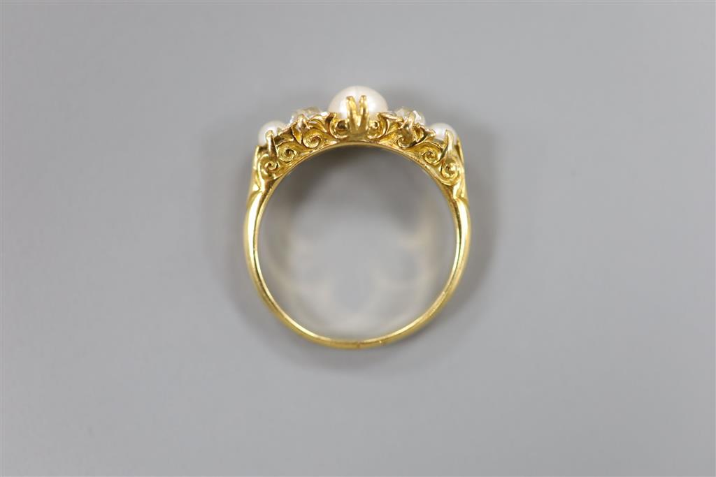 An Edwardian yellow metal, split pearl and diamond set half hoop ring, size N, gross 3.6 grams.